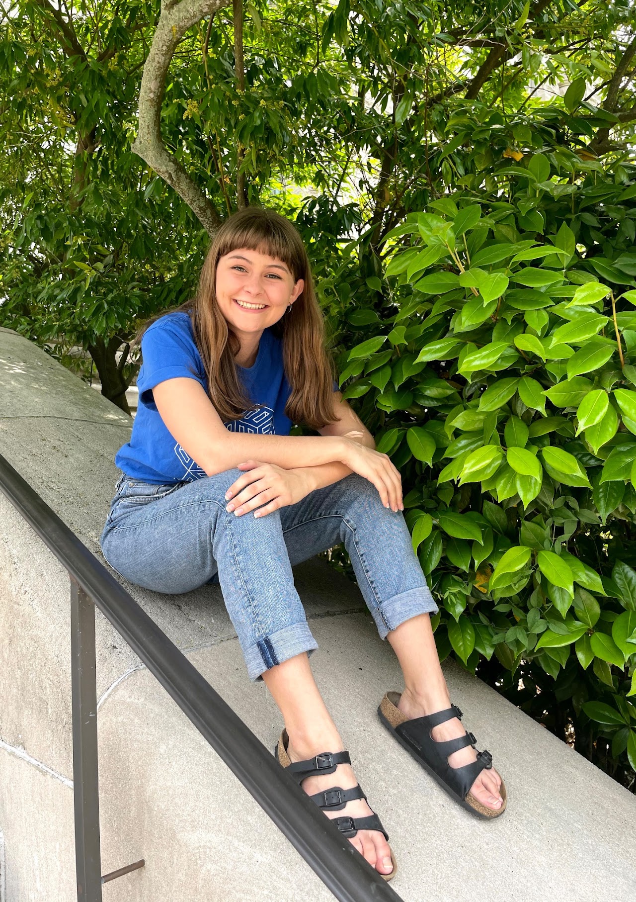 picture of Addie sitting outside on a stair railing